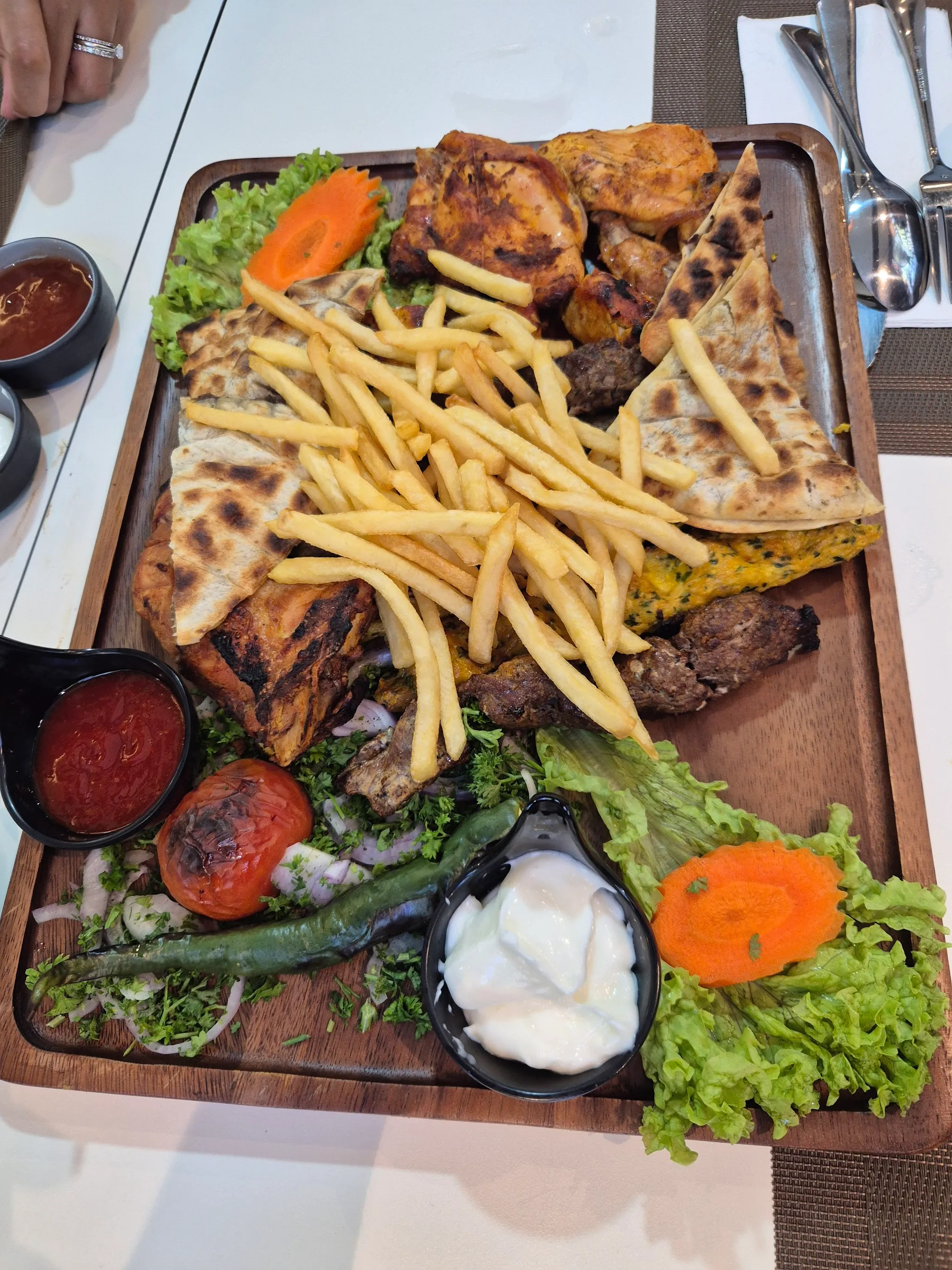 Mixed grill platter with grilled chicken, kofta kebab, flatbread and fries
