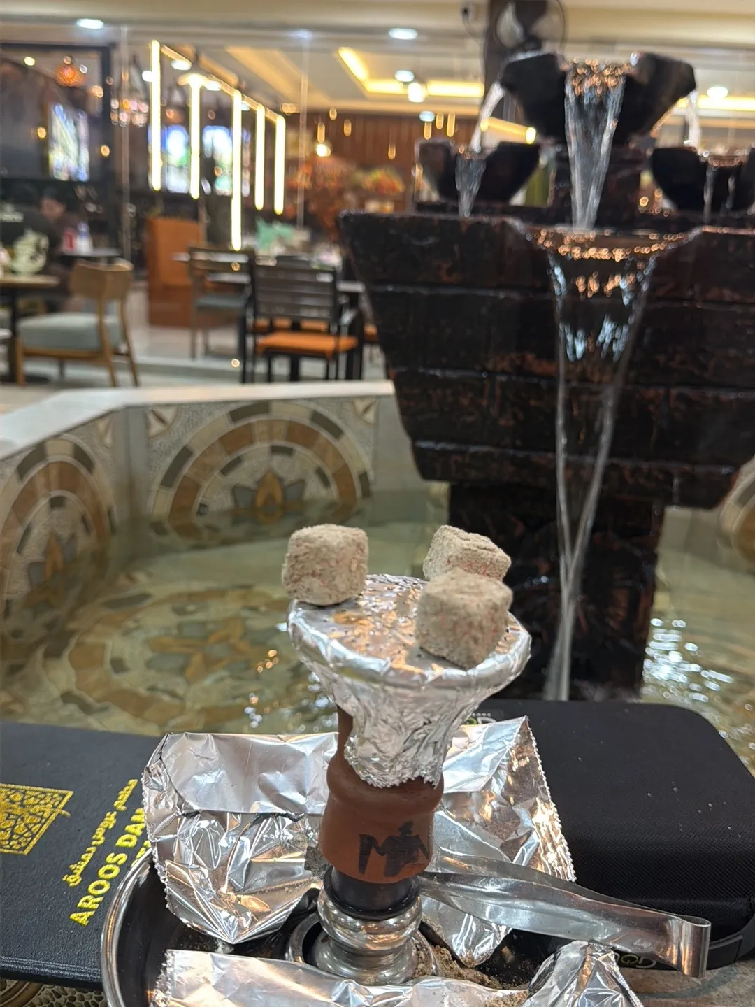 Shisha beside the indoor fountain in the dining area